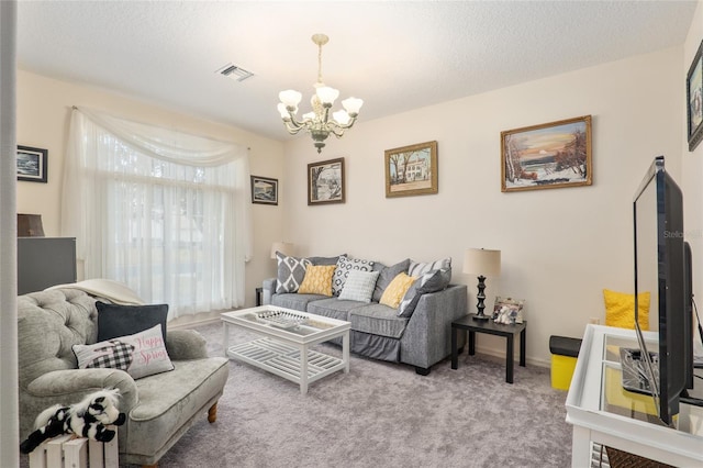 living room with light colored carpet, a textured ceiling, and an inviting chandelier