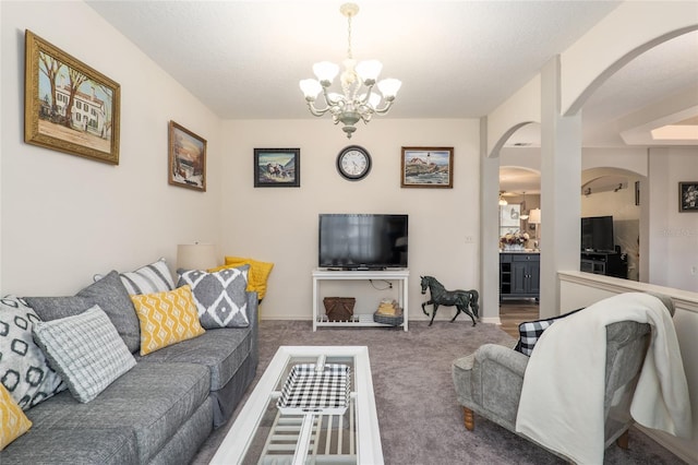 carpeted living room featuring a textured ceiling and an inviting chandelier