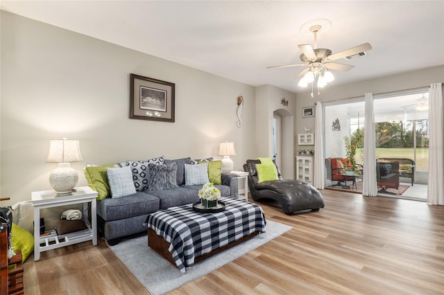 living room with hardwood / wood-style flooring and ceiling fan