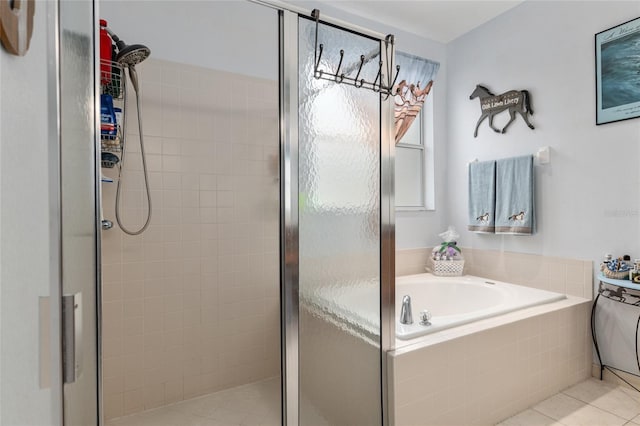 bathroom with shower with separate bathtub and tile patterned floors