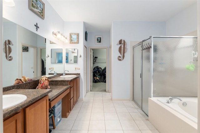 bathroom featuring tile patterned floors, vanity, and shower with separate bathtub