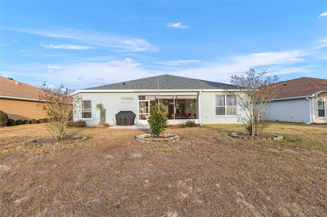 back of property with a lawn and a patio