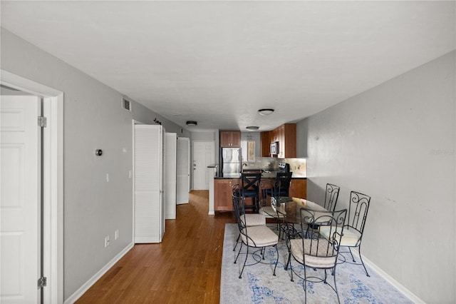 dining space featuring dark wood-type flooring