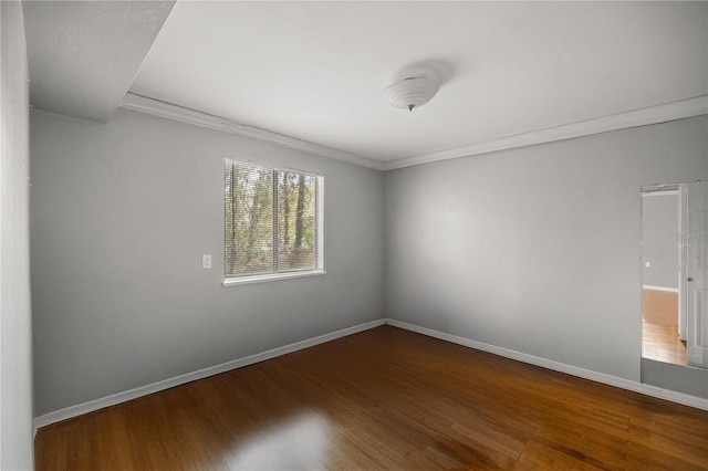 unfurnished room featuring hardwood / wood-style flooring and crown molding