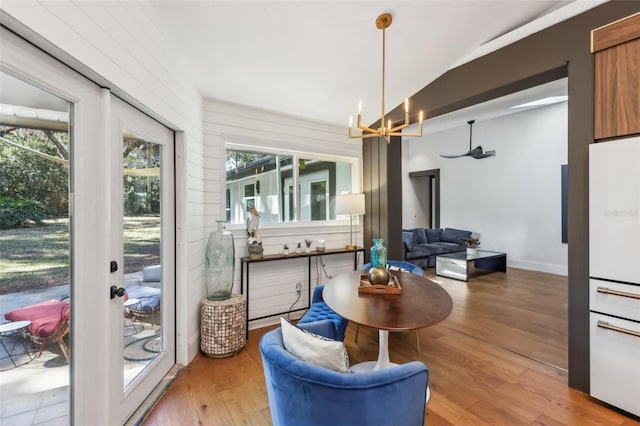 sunroom featuring a chandelier and lofted ceiling