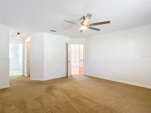 empty room with ceiling fan and carpet