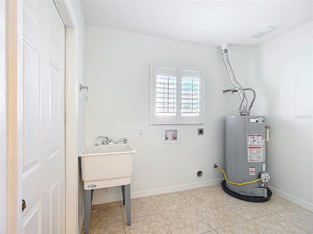 clothes washing area with hookup for a washing machine, light tile patterned floors, gas water heater, and hookup for an electric dryer