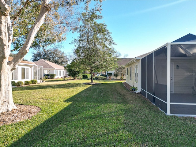 view of yard featuring glass enclosure