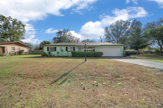 ranch-style home featuring a front lawn and a garage