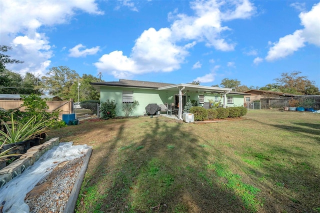 rear view of property with a yard