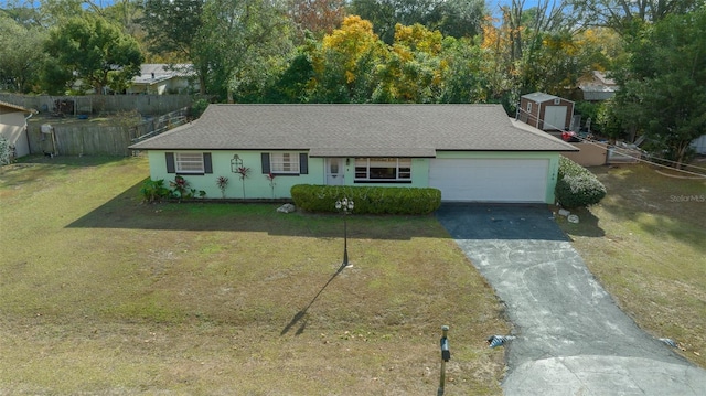 ranch-style home featuring a front lawn and a garage