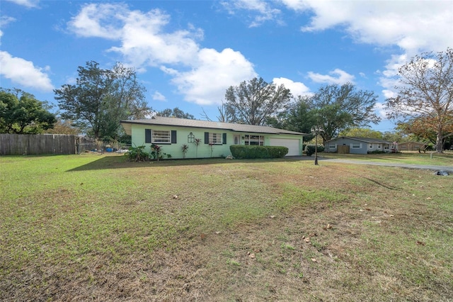 single story home with a garage and a front yard