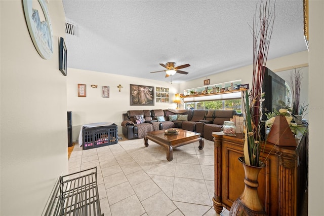 tiled living room featuring ceiling fan and a textured ceiling