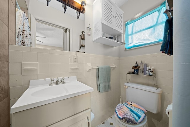 bathroom featuring a textured ceiling, vanity, tile walls, and toilet