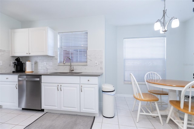 kitchen with white cabinets, sink, light tile patterned floors, decorative light fixtures, and dishwasher