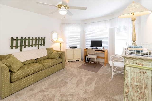 carpeted office featuring ceiling fan