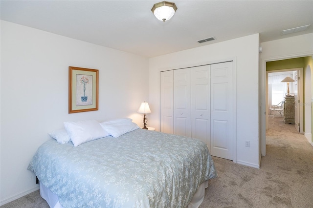 carpeted bedroom with a closet