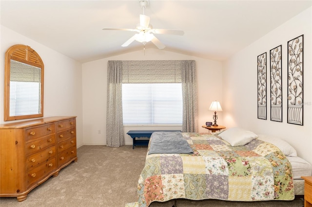 carpeted bedroom featuring ceiling fan and vaulted ceiling