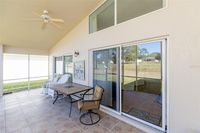 sunroom featuring ceiling fan and vaulted ceiling