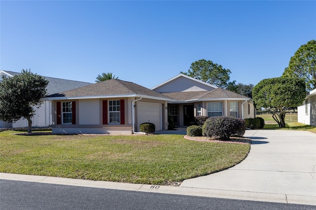 single story home featuring a garage and a front lawn