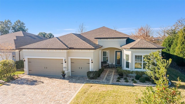 view of front of property with a front yard and a garage