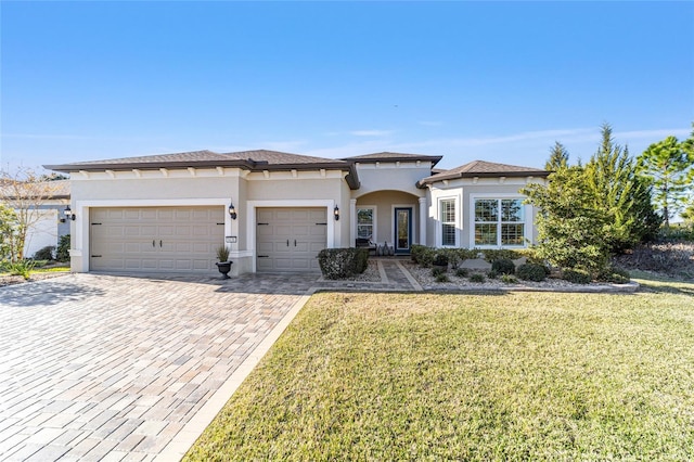 view of front of property with a front yard and a garage