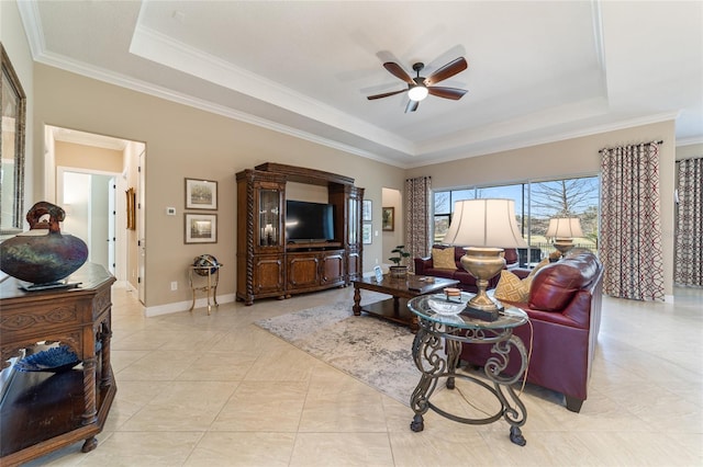 living room featuring a raised ceiling, ceiling fan, and crown molding