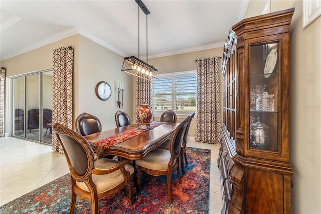 dining room featuring a notable chandelier, light tile patterned floors, and crown molding