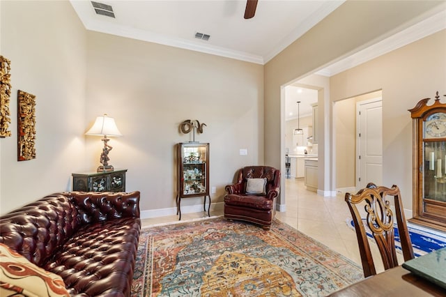 tiled living room featuring ceiling fan and ornamental molding