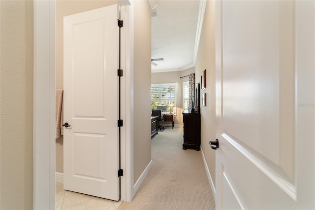 hall featuring light colored carpet and ornamental molding