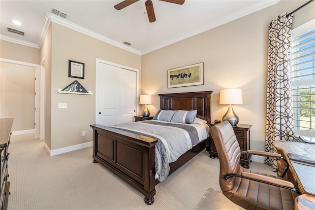 carpeted bedroom featuring ceiling fan, a closet, and crown molding