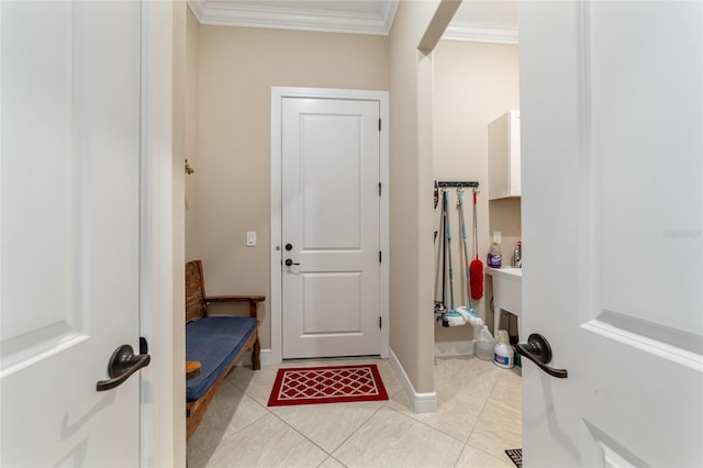 doorway to outside with crown molding and light tile patterned floors