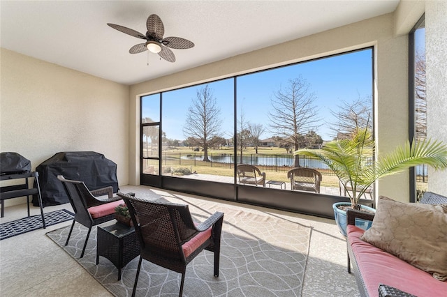 interior space with ceiling fan and a water view