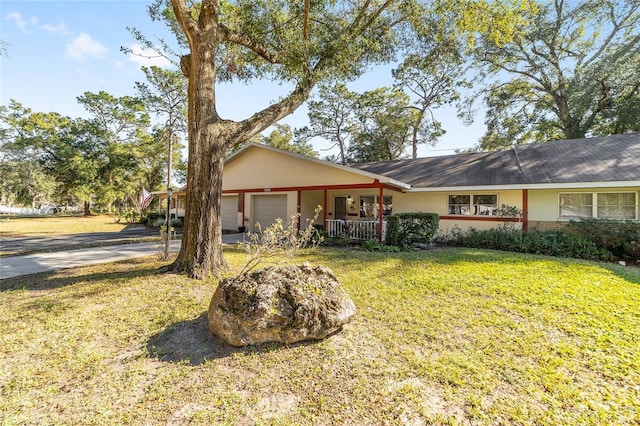 single story home featuring a garage and a front yard