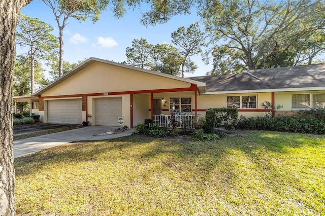 ranch-style home with covered porch, a garage, and a front yard