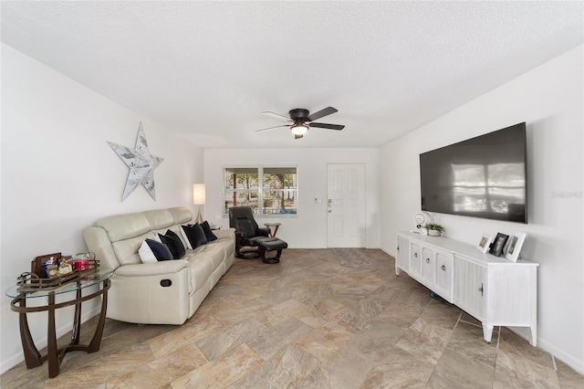 living room with a textured ceiling and ceiling fan