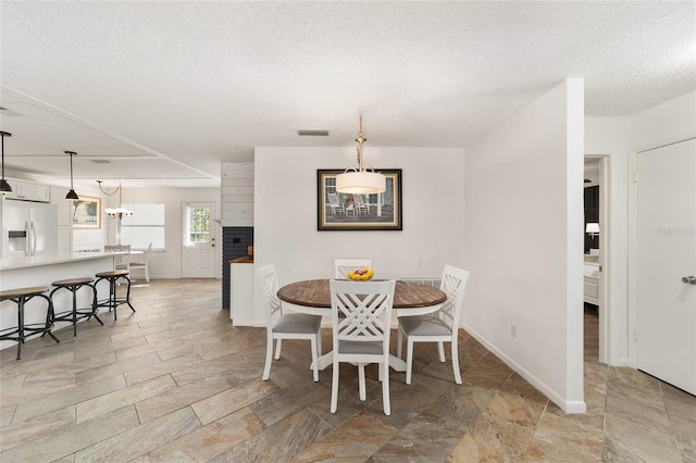 dining room featuring a textured ceiling