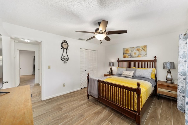 bedroom with ceiling fan, a closet, and a textured ceiling