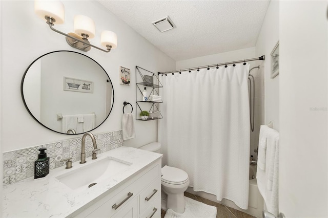 full bathroom with vanity, shower / bath combination with curtain, tile patterned flooring, toilet, and a textured ceiling