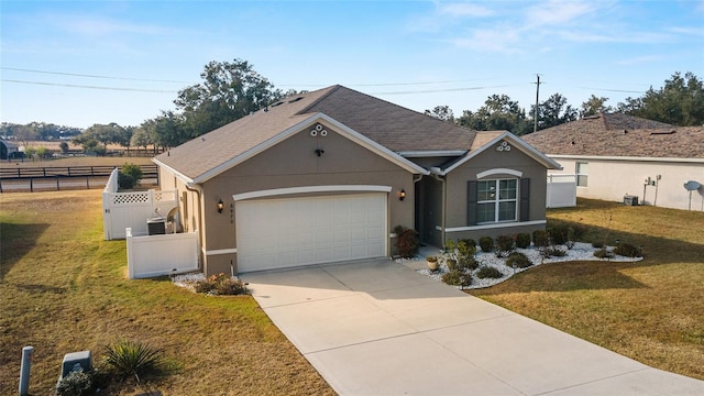 ranch-style house featuring a front yard and a garage