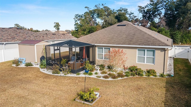 rear view of property with a lanai and a lawn