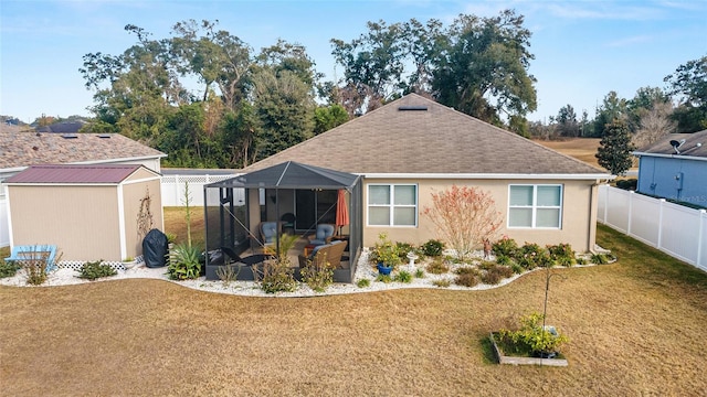 exterior space featuring a lanai, a front yard, and a storage shed