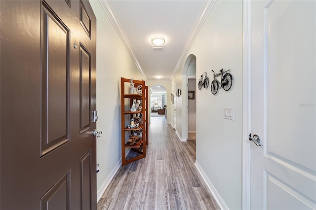 hall featuring wood-type flooring and ornamental molding