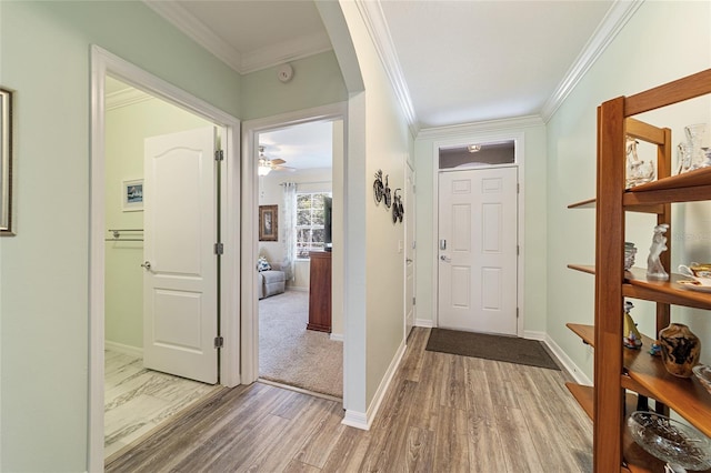 entryway with hardwood / wood-style floors, ceiling fan, and ornamental molding