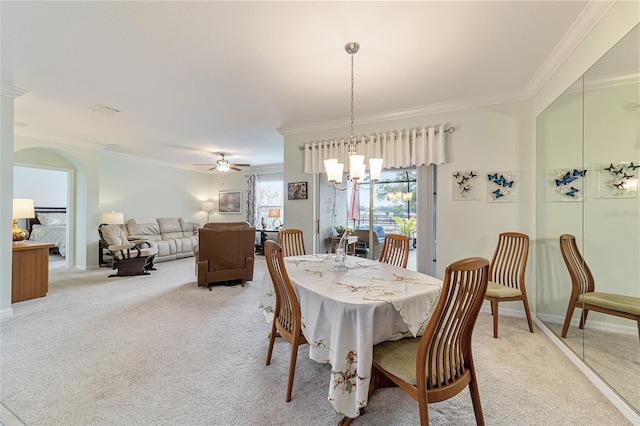 dining area with ceiling fan with notable chandelier, crown molding, and light carpet