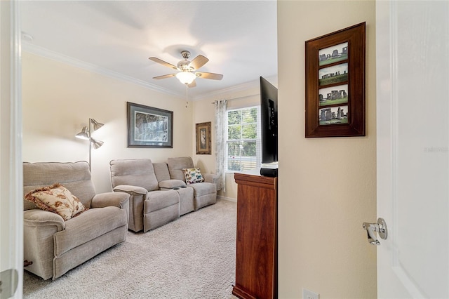 carpeted living room with ceiling fan and ornamental molding