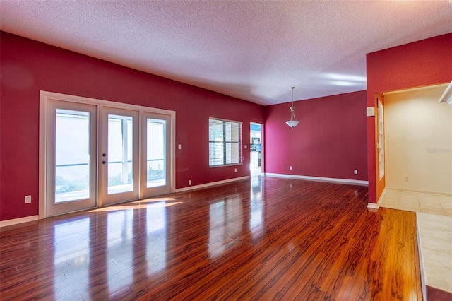 interior space featuring hardwood / wood-style flooring and a textured ceiling