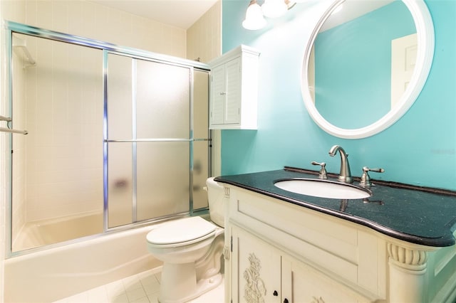 full bathroom with shower / bath combination with glass door, vanity, toilet, and tile patterned flooring