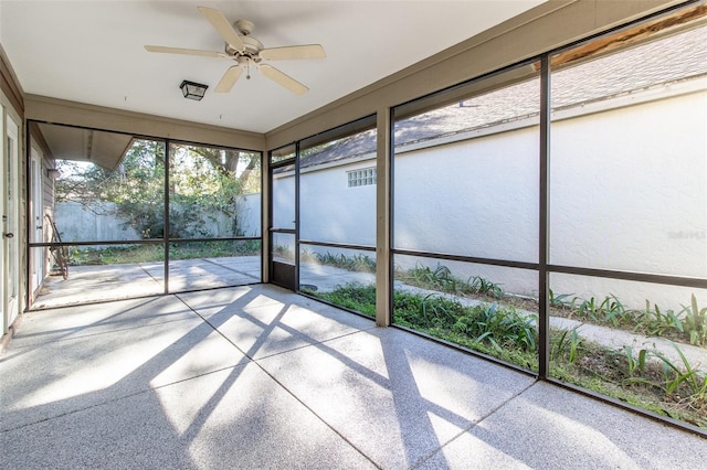 unfurnished sunroom with ceiling fan