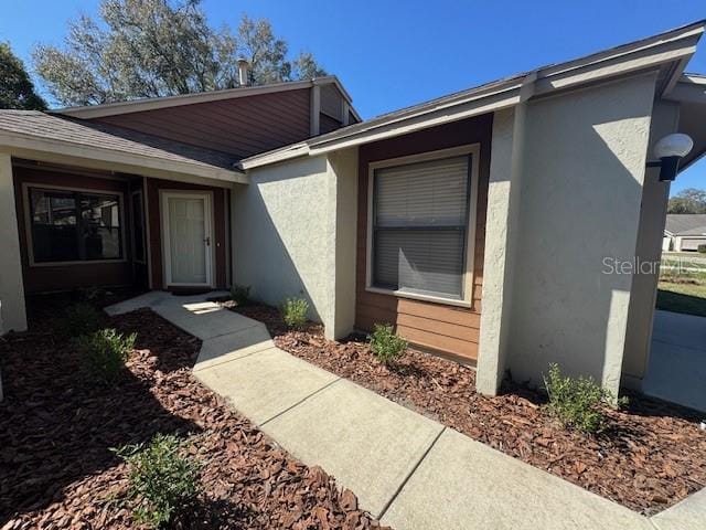 property entrance featuring stucco siding